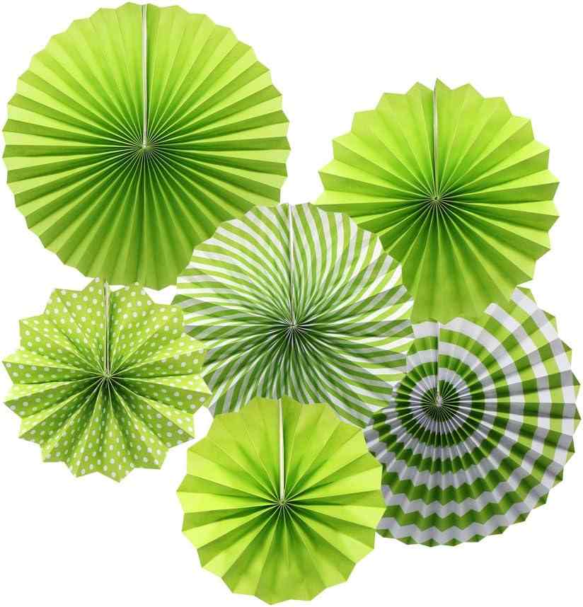 Decorative green paper fans for events and outdoor gatherings.
